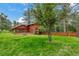 Charming wooden home with a deck and a spacious, tree-filled backyard at 29090 Golf Way, Evergreen, CO 80439
