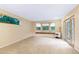 Bright living room with cozy window seat, fireplace, and access to the outdoors at 29090 Golf Way, Evergreen, CO 80439
