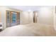 Spacious living room with neutral carpet, and doors to outdoor view at 29090 Golf Way, Evergreen, CO 80439