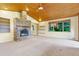 Expansive living room with a stone fireplace and views of the surrounding nature for serene living at 29090 Golf Way, Evergreen, CO 80439