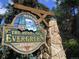 Charming 'Welcome to Evergreen' sign with mountain and evergreen tree imagery at 29090 Golf Way, Evergreen, CO 80439