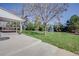 Grassy backyard with a concrete patio, mature trees, and shrubs perfect for outdoor entertaining and activities at 6708 S Niagara Ct, Centennial, CO 80112