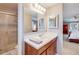 This bathroom features a vanity, mirror, and a glass door shower at 6708 S Niagara Ct, Centennial, CO 80112