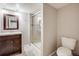 Well-lit bathroom boasts a glass door shower, modern vanity, tile flooring, and a comfort height toilet at 6708 S Niagara Ct, Centennial, CO 80112