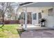 Covered patio with stone walkway features a grill, a ceiling fan, and access to a spacious, lush backyard at 6708 S Niagara Ct, Centennial, CO 80112