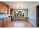 Bright dining area with hardwood floors, stylish chandelier, and large windows providing a view of outdoors at 6708 S Niagara Ct, Centennial, CO 80112