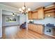 Bright dining area with hardwood floors open to living room, stylish chandelier, and ample cabinetry at 6708 S Niagara Ct, Centennial, CO 80112