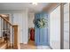 Welcoming entryway with hardwood floors, a decorative wreath on the front door, and a staircase at 6708 S Niagara Ct, Centennial, CO 80112