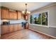 Bright eat-in kitchen featuring wood cabinets, granite countertops and large windows overlooking the landscaped yard at 6708 S Niagara Ct, Centennial, CO 80112