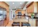 This kitchen is beautiful and bright with wooden cabinets, stainless steel appliances, and a granite countertop island at 6708 S Niagara Ct, Centennial, CO 80112
