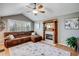 This cozy living room offers comfort with hardwood floors, fireplace, and a vaulted ceiling for relaxation at 6708 S Niagara Ct, Centennial, CO 80112