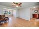 Spacious living room with hardwood floors, connected to dining area, creating an open and airy feel at 6708 S Niagara Ct, Centennial, CO 80112