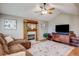 Bright living room featuring a fireplace, ceiling fan, hardwood floors and natural light for a relaxing space at 6708 S Niagara Ct, Centennial, CO 80112