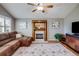 Cozy living room with hardwood floors, fireplace, ceiling fan, and neutral paint creates a welcoming ambiance at 6708 S Niagara Ct, Centennial, CO 80112
