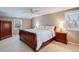 Comfortable bedroom with natural light, wood furniture, and neutral tones creates a peaceful retreat at 6708 S Niagara Ct, Centennial, CO 80112