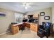 A home office with a built-in desk, cabinets, and a comfortable chair at 6708 S Niagara Ct, Centennial, CO 80112