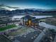 Aerial view of the house showing the exterior, beautiful mountain view and well-manicured lawn and landscaping at 8727 Hunters Hill Ln, Littleton, CO 80125