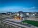 Aerial view of home showing the large backyard, shed, lush lawn, and retaining wall landscaping at 8727 Hunters Hill Ln, Littleton, CO 80125