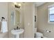 This is a powder bathroom featuring a modern pedestal sink and decor at 8727 Hunters Hill Ln, Littleton, CO 80125
