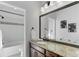 Bathroom with granite vanity top, dark wood cabinets, and a shower/tub combo at 8727 Hunters Hill Ln, Littleton, CO 80125