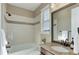A clean bathroom features a shower and soaking tub with dark brown cabinets at 8727 Hunters Hill Ln, Littleton, CO 80125