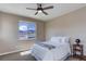 Cozy bedroom with soft carpet, ceiling fan, and bright window with mountain view at 8727 Hunters Hill Ln, Littleton, CO 80125