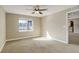 Spacious bedroom with carpet, a ceiling fan, and a large window showcasing mountain views at 8727 Hunters Hill Ln, Littleton, CO 80125