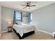 Comfortable bedroom with carpet flooring, ceiling fan, and natural lighting at 8727 Hunters Hill Ln, Littleton, CO 80125