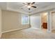 Bright bedroom with a ceiling fan and ensuite bathroom offering comfort and convenience at 8727 Hunters Hill Ln, Littleton, CO 80125