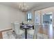 Dining room with modern chandelier and elegant decor on dark wood floor at 8727 Hunters Hill Ln, Littleton, CO 80125
