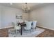 Dining room with modern chandelier and elegant decor on dark wood floor at 8727 Hunters Hill Ln, Littleton, CO 80125