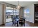 Dining room with sliding glass doors to balcony and views of mountains and river at 8727 Hunters Hill Ln, Littleton, CO 80125