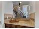 Hallway with granite countertop and view to stairs and Gathering room with a fireplace at 8727 Hunters Hill Ln, Littleton, CO 80125