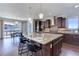 Luxury kitchen island with bar seating, pendant lights, stainless appliances and mountain views at 8727 Hunters Hill Ln, Littleton, CO 80125