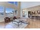 Spacious living room with hardwood floors, high ceilings, and large windows with mountain views at 8727 Hunters Hill Ln, Littleton, CO 80125