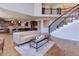 Open floorplan showing living room and kitchen, and grand staircase with wrought iron banister at 8727 Hunters Hill Ln, Littleton, CO 80125