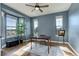 Office with bright blue walls, large windows and views, and wood flooring at 8727 Hunters Hill Ln, Littleton, CO 80125