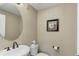 Elegant powder room features stylish fixtures and a decorative mirror creating a charming space at 8727 Hunters Hill Ln, Littleton, CO 80125