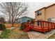 Well-maintained backyard with a wooden deck and lush green lawn at 10652 Hyacinth St, Highlands Ranch, CO 80129