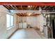 Unfinished basement with washer, dryer, and ample space for storage and utilities at 10652 Hyacinth St, Highlands Ranch, CO 80129