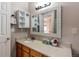 Bathroom vanity with a sink, a mirror, and wood cabinets at 10652 Hyacinth St, Highlands Ranch, CO 80129