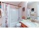 Bathroom with a shower-tub combo, tile surround, and modern sink at 10652 Hyacinth St, Highlands Ranch, CO 80129