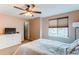 Bedroom featuring neutral walls, ceiling fan and carpeted floor with large window at 10652 Hyacinth St, Highlands Ranch, CO 80129