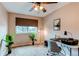 Bright bedroom featuring a ceiling fan, desk, and large window, perfect for a home office at 10652 Hyacinth St, Highlands Ranch, CO 80129