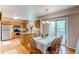 Bright dining area with wood floors, chandelier, and sliding glass doors to a deck at 10652 Hyacinth St, Highlands Ranch, CO 80129
