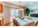 Dining area with table, chairs, and chandelier near sliding glass door at 10652 Hyacinth St, Highlands Ranch, CO 80129