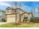 Charming two-story home with a well-manicured lawn and a brick-accented facade at 10652 Hyacinth St, Highlands Ranch, CO 80129