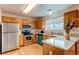 Well-equipped kitchen with stainless steel appliances, wood cabinets, and breakfast bar at 10652 Hyacinth St, Highlands Ranch, CO 80129