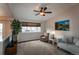 Bright living room featuring a TV, large window, and comfortable seating at 10652 Hyacinth St, Highlands Ranch, CO 80129