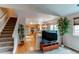 Open-concept living room with stairs and a view into the kitchen area at 10652 Hyacinth St, Highlands Ranch, CO 80129